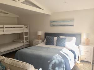 a bedroom with a bed and a bunk bed at Bijoux Beach House in Freshwater