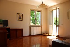 a living room with a couch and a large window at Appartamenti Pura Vida in Fano