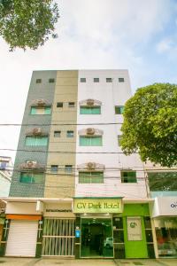 a tall white building with a gay dark hotel at Gv Park Hotel in Governador Valadares