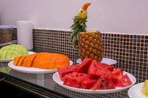 a table with plates of fruit on top at Gv Park Hotel in Governador Valadares