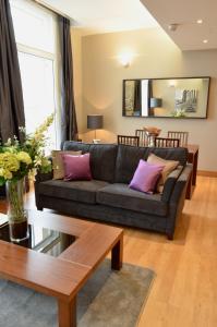 a living room filled with furniture and a couch at Quebecs Luxury Apartments in Leeds