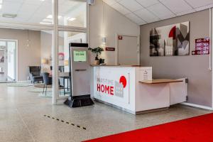 an office lobby with a home appliance in a room at Part-Time Home Rotebro in Rotebro