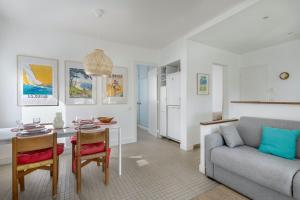 a living room with a couch and a table at Votre cocon à proximité de la plage de La Baule in La Baule
