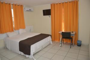 A bed or beds in a room at Petro Plaza Hotel