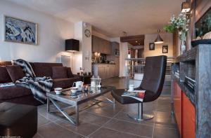 uma sala de estar com um sofá e uma mesa em CGH Résidences & Spas Le Centaure em Flaine