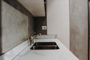 a kitchen counter with a sink in a room at Ivy Lalzi Bay Beach House in Durrës +29 photos