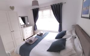 a bedroom with a bed with towels on it at Prince Apartments in Fareham