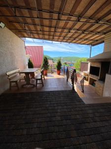 a patio with a picnic table and a fireplace at Guest House Milana in Novomikhaylovskiy