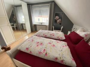 1 dormitorio con 1 cama y 1 sofá rojo en Steinberg-Blick, en Herzberg am Harz