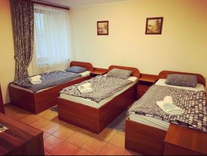 a room with three beds in a room at Zakarpatska Kolyba in Odesa