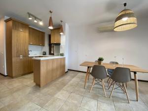 a kitchen with a wooden table and chairs at Sozopolis Holiday Village in Sozopol