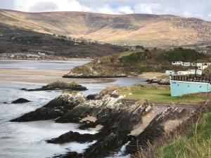 a house on the shore of a body of water at Derrynane Bay House in Caherdaniel