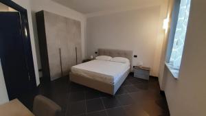 um quarto com uma cama branca e uma janela em Ca' L'Archetto intero appartamento centro Cremona em Cremona