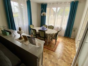 a kitchen and dining room with a table and chairs at "LA VERANDA" Gîte in Verdigny