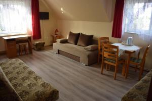 a living room with a couch and a table at Pokoje U Emilii in Kąty Rybackie