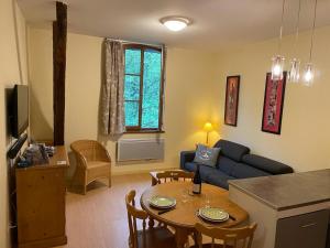 a living room with a couch and a table at Résidence Grand Hôtel Appartement Standing in Aulus-les-Bains