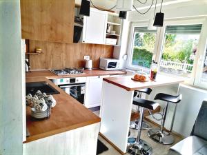 a kitchen with white cabinets and a counter top at Apartman Anamaria in Gospić