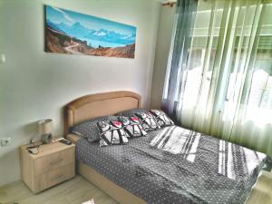 a bedroom with a bed with pillows and a window at Apartman Anamaria in Gospić