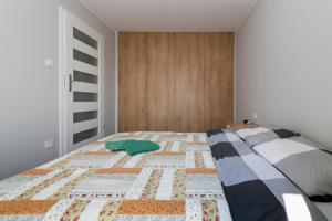 Posteľ alebo postele v izbe v ubytovaní Apartamenty Gdynia