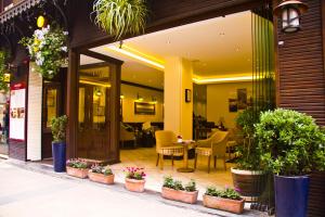 a restaurant with potted plants in front of a building at Ilkay Hotel in Istanbul