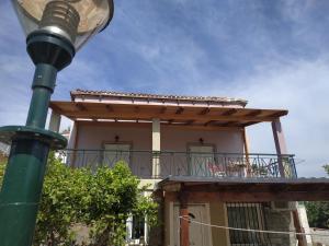 a house with a deck and a street light at Near AirportAnd metropolitan Penelopi Cozy Home in Artemida