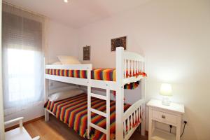 a bedroom with two bunk beds and a window at Apartamentos Alborada III in Vera +238 photos