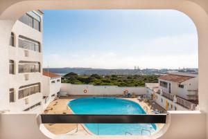 a view from the balcony of a building with a swimming pool at Aparthotel Navigator in Sagres +17 photos