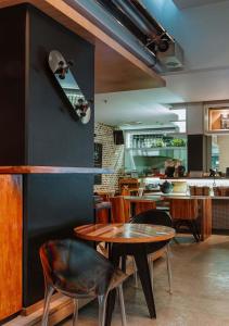 a restaurant with tables and chairs and a counter at The Click Clack Hotel Bogotá in Bogotá