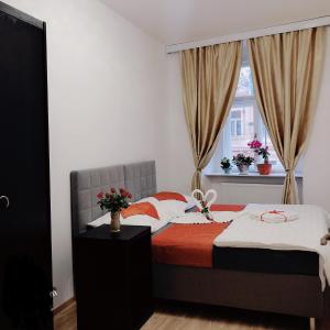 a bedroom with a bed and a window at Lena Apartment in Prague