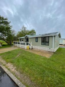 a house with a large yard in front of it at Torrey Pines - 2 bedroom hot tub lodge with free golf, NO BUGGY in Swarland