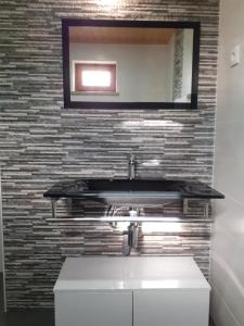 a bathroom with a sink and a mirror at Casa Mota Pinto in Castro Daire +12 photos