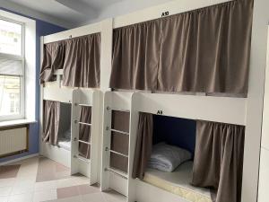a room with a bunk bed with windows at If Hostel in Lviv