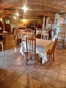 a restaurant with tables and chairs in a room at Locanda Dei Gelsi in Villar San Costanzo +29 photos