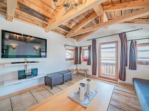 a living room with a blue couch and a table at Chalet Kirchberg in Kirchberg in Tirol