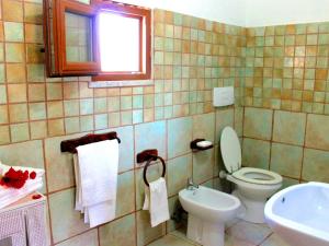 a bathroom with a toilet and a sink at d Pietraia 13B Trilo in Badesi +10 photos
