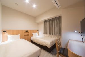 Postel nebo postele na pokoji v ubytování Nesthotel alt Kuramae Station