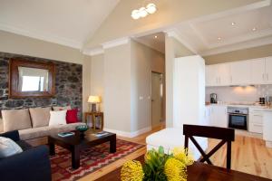 a living room with a couch and a table at The Docks Ocean Front Villas - Next to Beach in Paul do Mar