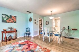 a living room with blue walls and a table and chairs at Fort Walton Coastal Retreat with Yard Walk to Beach in Fort Walton Beach