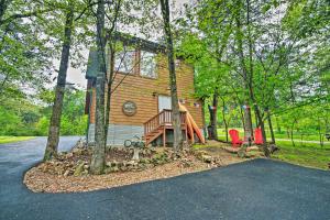 a log home with a playground in the woods at Bright Lakeside Studio - Hike, Fish, and Bike! in Golden
