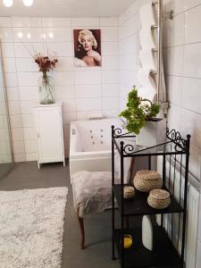 a bathroom with a bath tub and a sink at Lucia and Roland house in Falkenberg