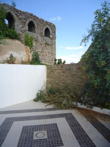 ein Backsteingebäude mit einer Ziegelwand und einem Gehweg in der Unterkunft Casa do Castelo in Redondo
