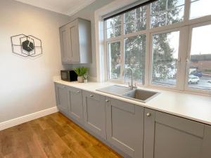 a kitchen with a sink and a window at Apartment 'Boho' in Yeovil