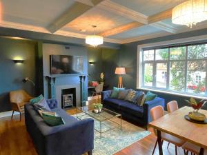 a living room with blue couches and a fireplace at Apartment 'Boho' in Yeovil