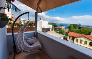 a hammock on a balcony with a view of a city at Duru Sultanahmet Apart & Suites in Istanbul