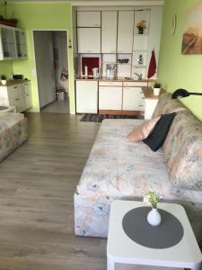 a living room with a couch and a table at Laboe-Hafen in Laboe +9 photos