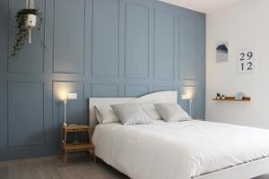 a bedroom with a large white bed with two lamps at ReGenzio in Colledara