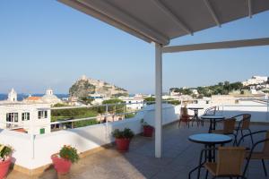 a balcony with tables and chairs and a view of the city at Hotel Villa Cecilia in Ischia