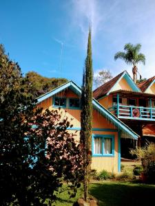 a house with a palm tree in front of it at Residencial Saldanha in Gramado
