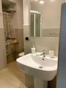 a bathroom with a white sink and a toilet at Casa Dante in Turin +12 photos