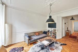 パリにあるCosy Apartment for 2 People near Pigalleのリビングルーム(ソファ、テーブル付)